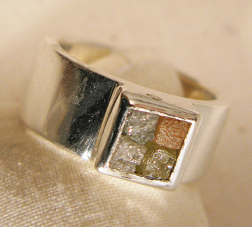 4 colored rough diamonds in silver band