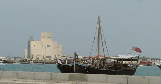 Boats in Dhow harbor, museum in the background