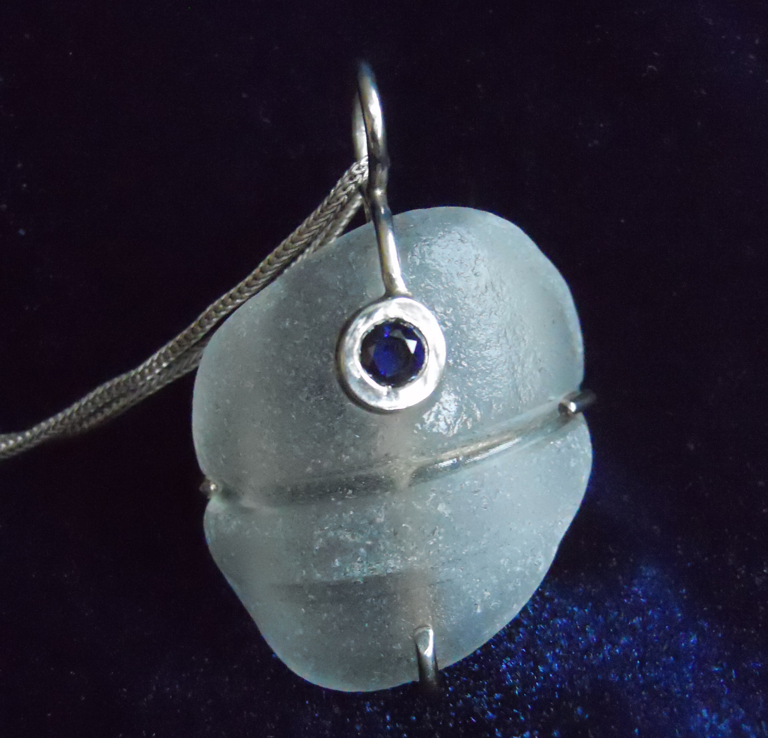 Blue sapphire over beach glass